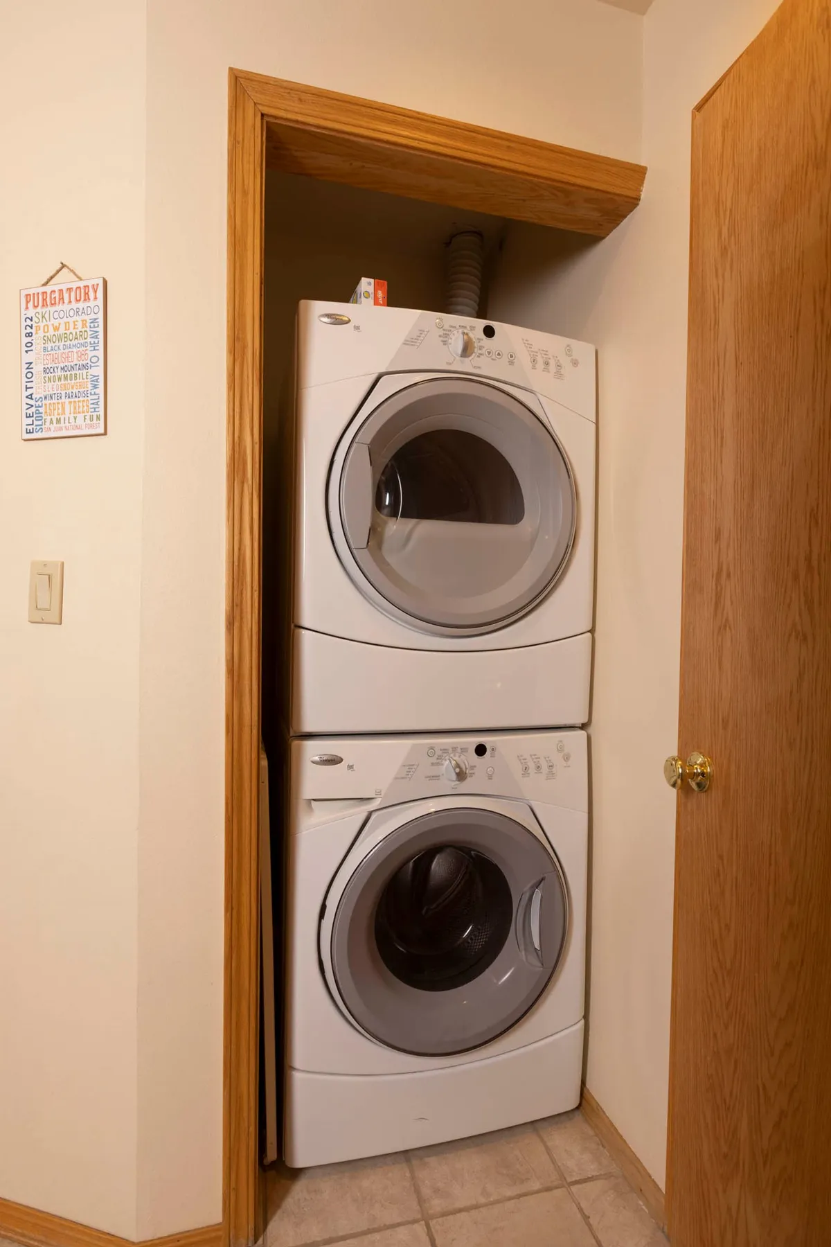 A practical laundry area with a stacked washer and dryer, accompanied by an elevation sign for a unique touch. The space is neat, organized, and reflective of everyday convenience within the resort.